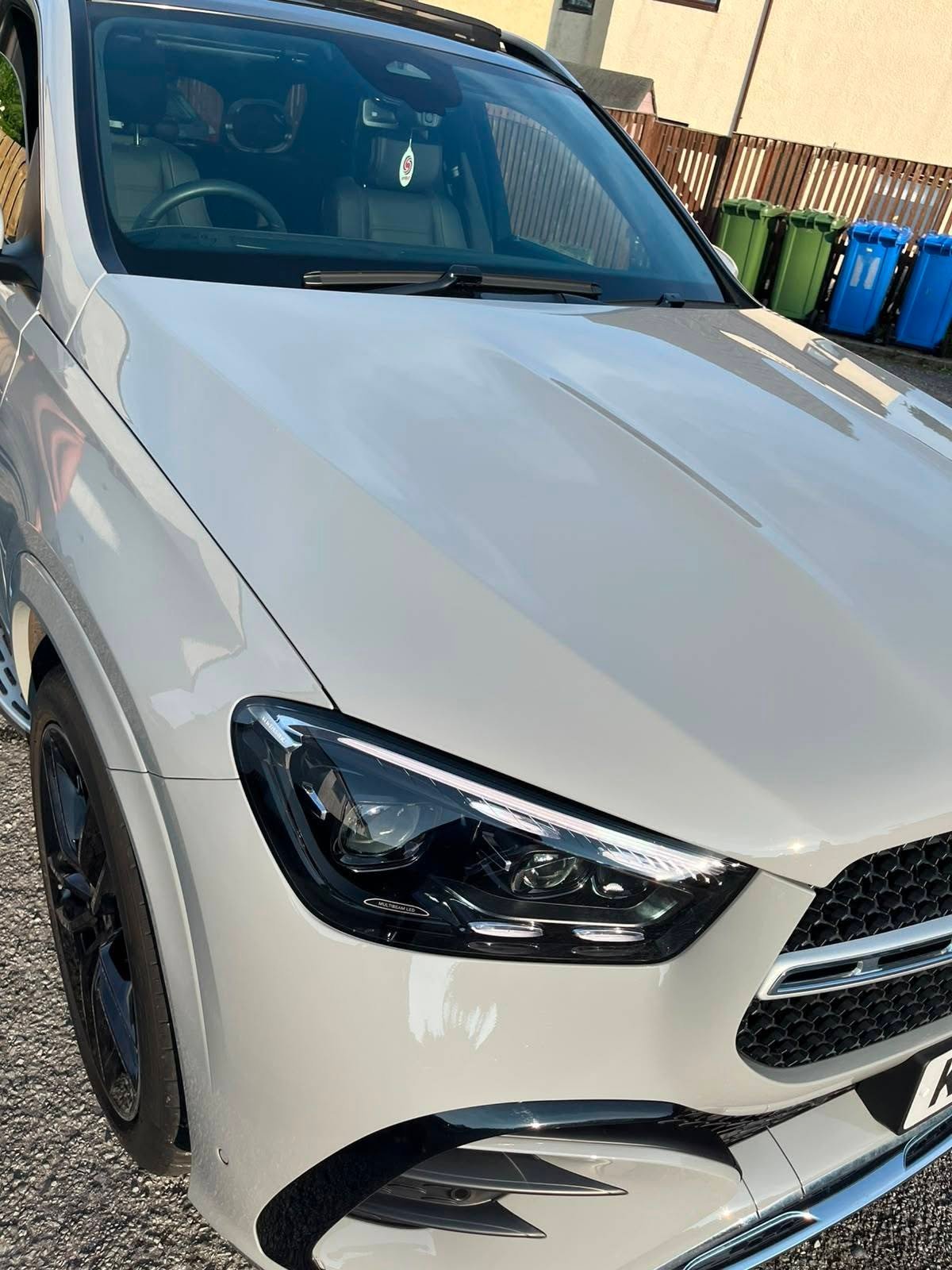 White SUV washed and finished after a full valet, parked on a driveway
